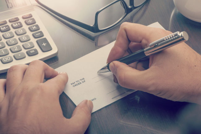 Man Writing A Payment Cheque